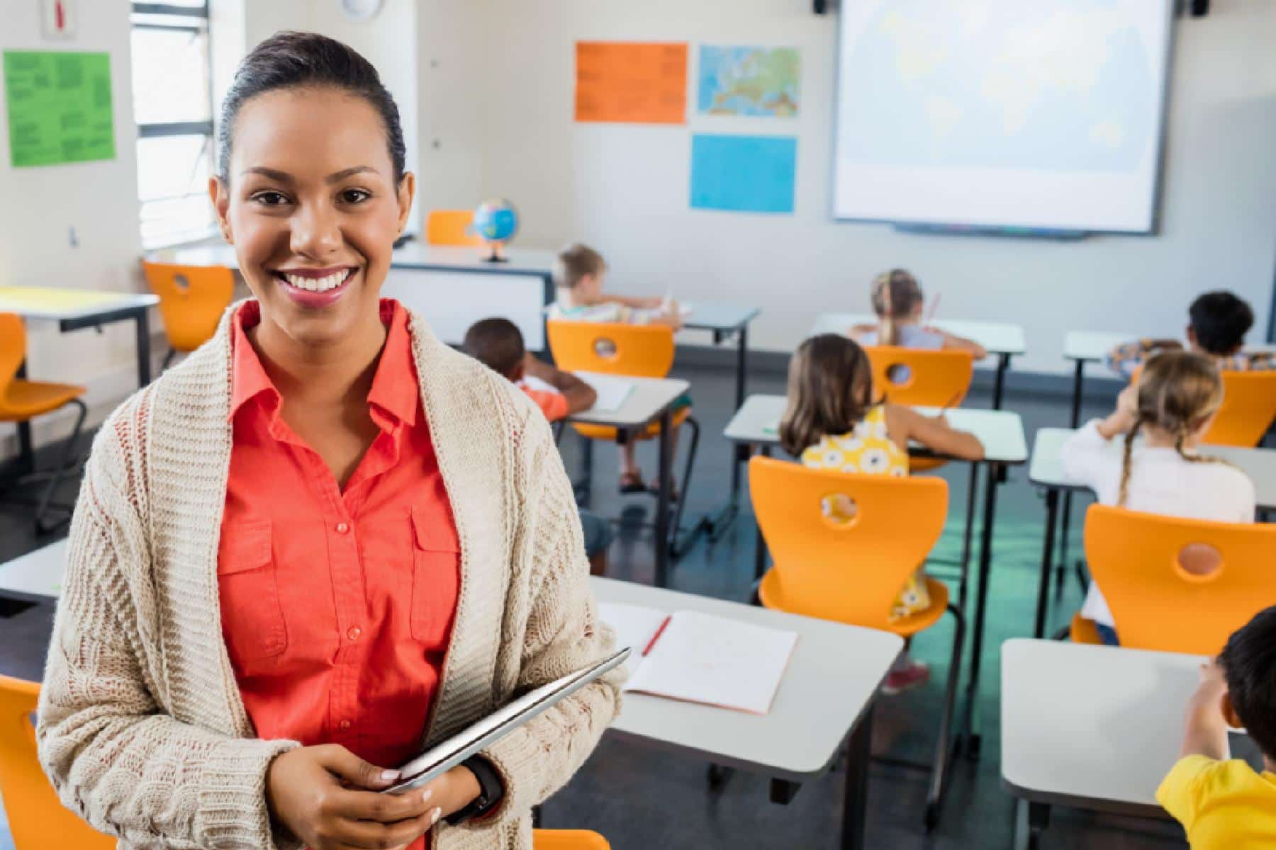 Teacher posing with her tablet at school