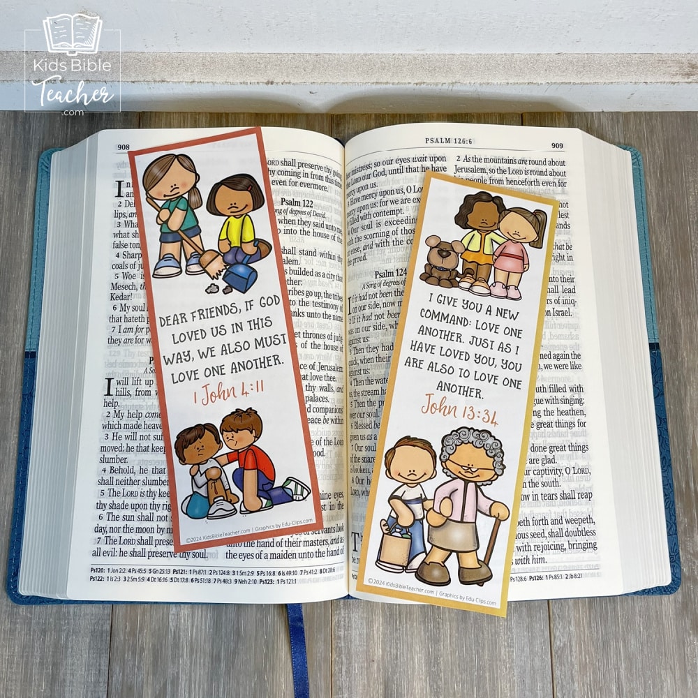 Picture of two of the God's Love Bookmarks with Valentine's Bible Verses set on an open Bible 
