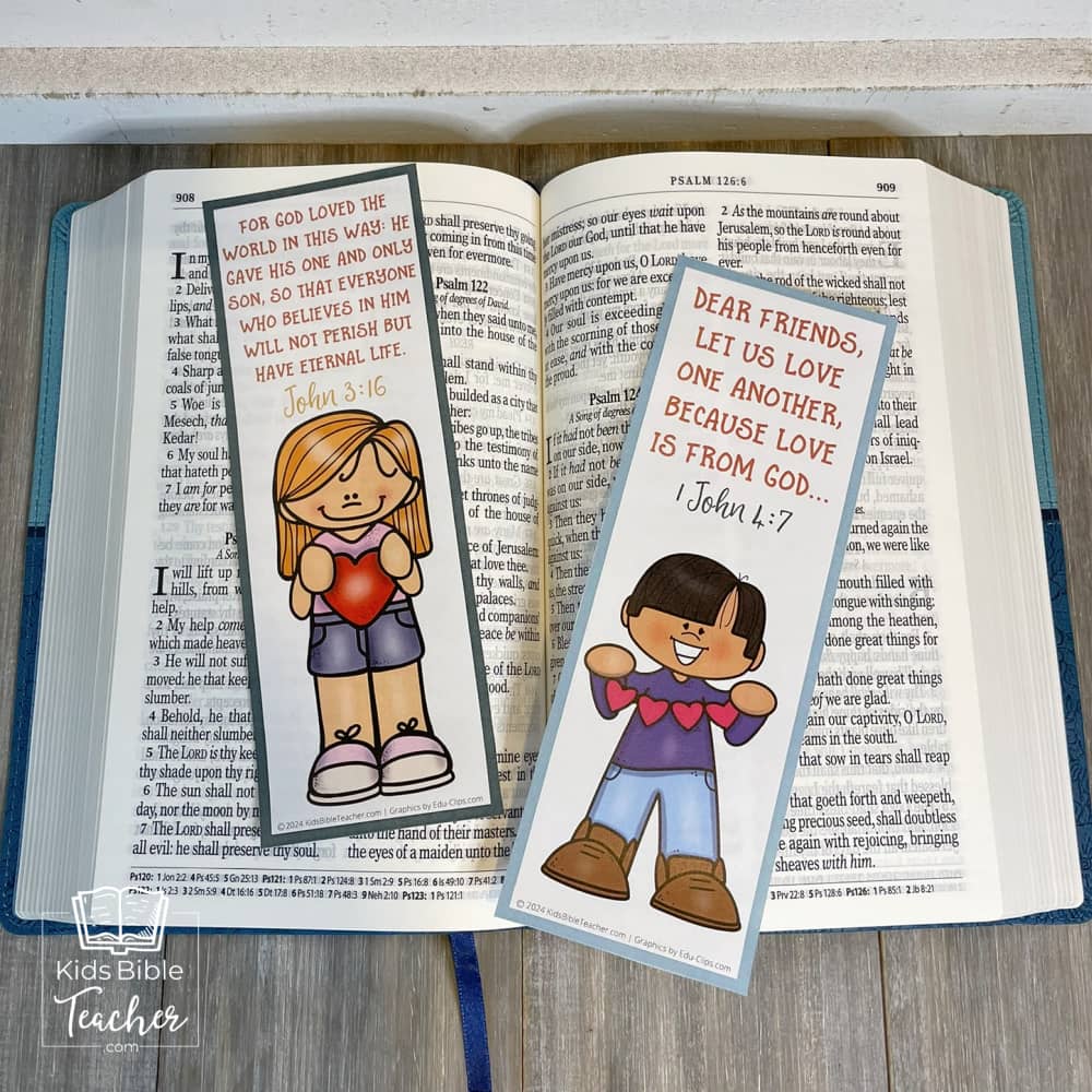 Picture of two of the God's Love Bookmarks with Valentine's Bible Verses set on an open Bible 